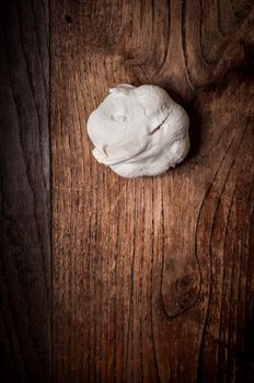 garlic on brown textured wood