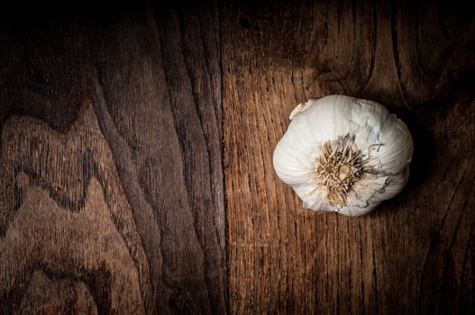 garlic on brown textured wood