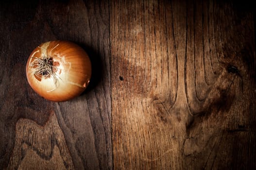 onion on textured brown wood