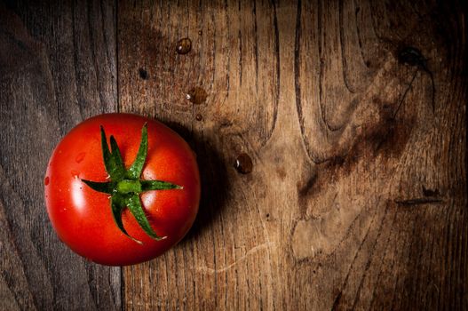 tomato on brown textured wood