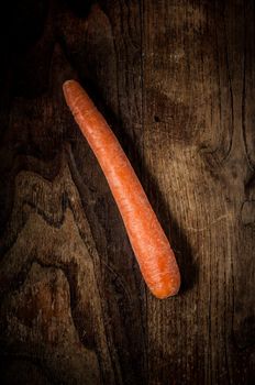 carrot on brown textured wood