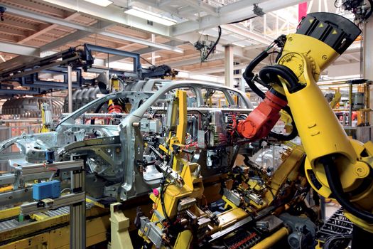 robots welding in an automobile factory 