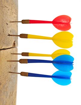 darts hitting in wooden wall