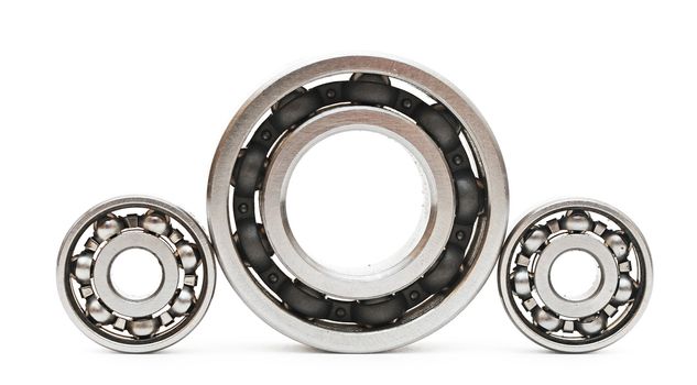 Big and small ball bearings on white background 