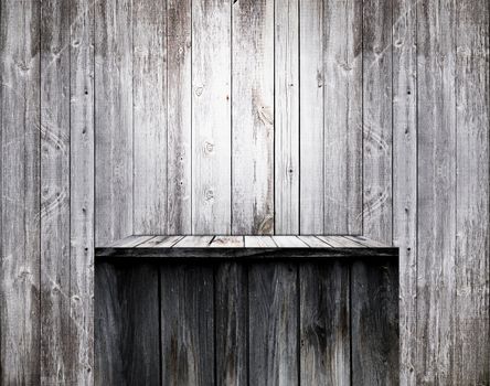 Empty wood shelf on old wall