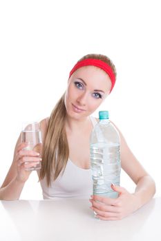Sporty woman with bottle and glass of pure water over white