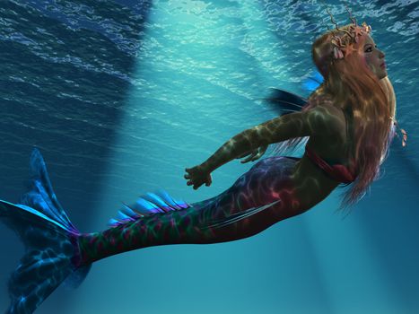 Ocean light illuminates a magical mermaid as she swims up to the ocean surface.