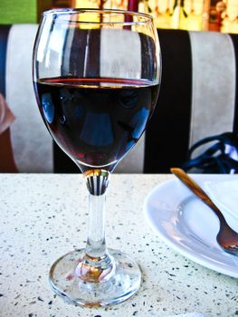 the image of glass of red wine on the table
