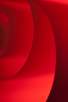 Spiraled red paper with a texture under soft light