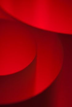 Red abstract forms by paper curls closeup