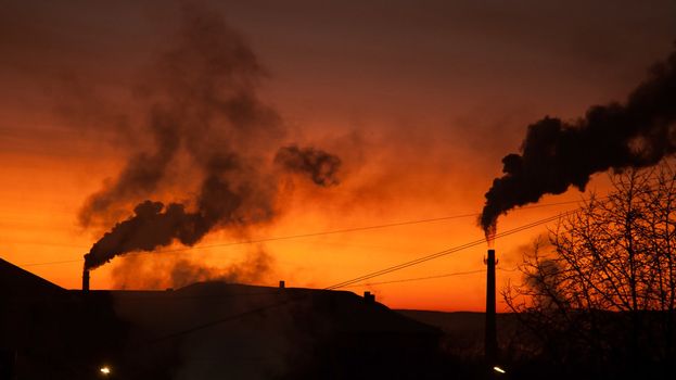 Town in the north. Tube boilers at sunset