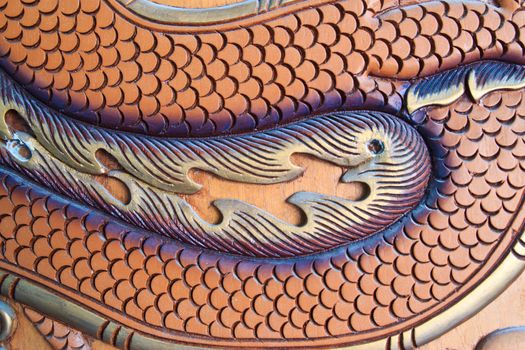 wood carving of a dragon at thailand
