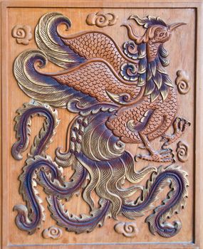 wood carving of a chicken at thailand