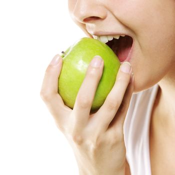 Beautiful young woman eating green apple. Isolated on white