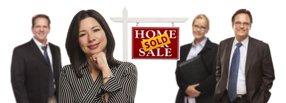 Pretty Hispanic Woman and Other People Behind in Front of Sold Home For Sale Real Estate Sign Isolated on a White Background.