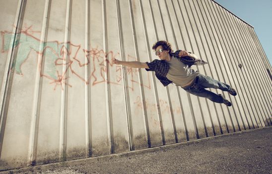 Young man feels like a superhero, flying free.
