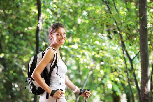 Woman walking cross country in forest