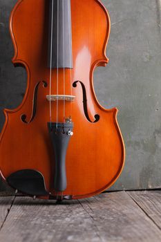 Close up of a violin on old wood background