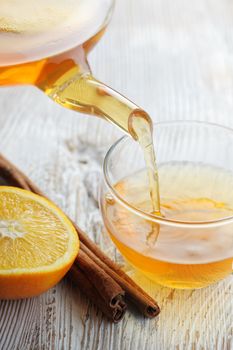 Pouring Tea into Glass Cup