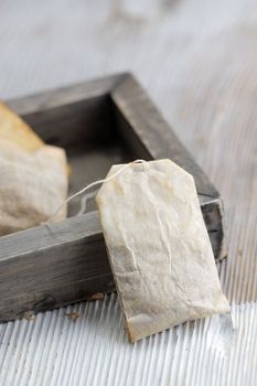 Tea bag on wood board, close up