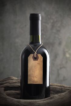Red wine bottle with old paper label, copy space on label