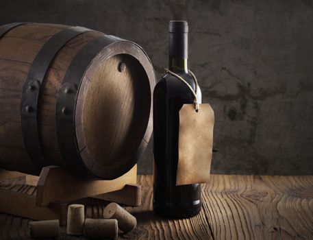 Wine bottle with barrel and old paper label