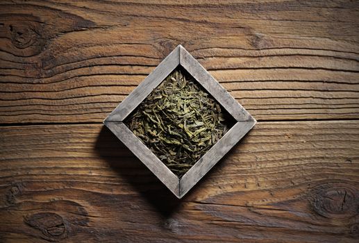 Pile of jasmine green tea in a wooden box