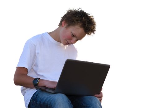 Pretty schoolboy with spiky hair work on mobile computer (isolated on white)