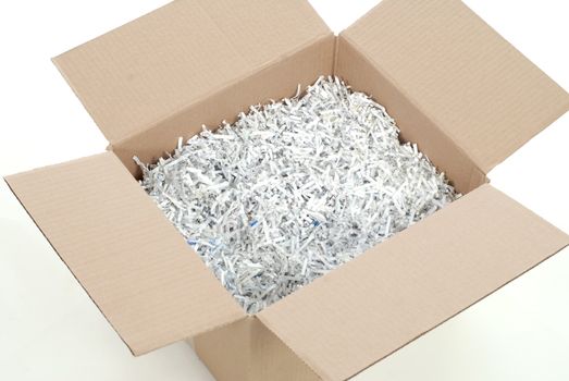 cardboard box full of shredded paper - packing box on white background