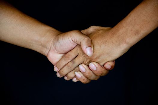 handshake on black background