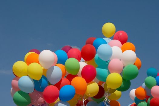 Countless colorful balloons flying in deep blue sky