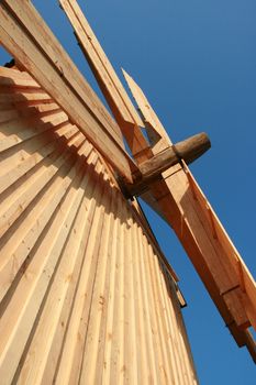 Rural wooden windmill against clear deep blue sky