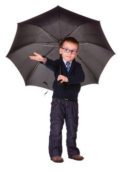 Boy in black clothes under big black umbrella check is it raining or not.  Isolated on white