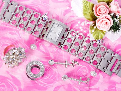 Jewelry and watches on a pink background