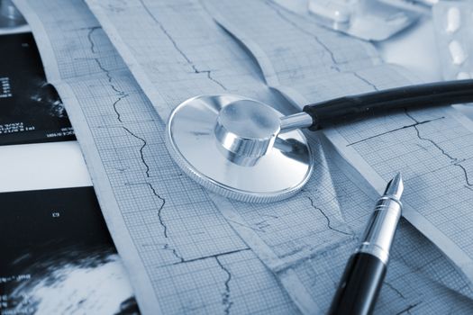 Cardiogram of the heart, stethoscope and pills