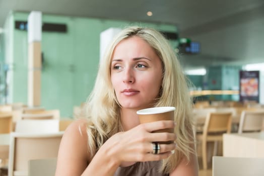 Portrait of beautiful woman having cup of coffee