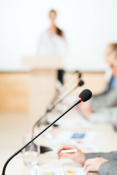 close-up microphone, on the background of business communication at the conference