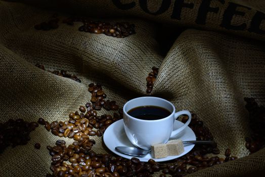 Coffee cup, beans and burlap. still life