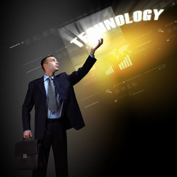 Businessman standing with modern technology symbols next to him