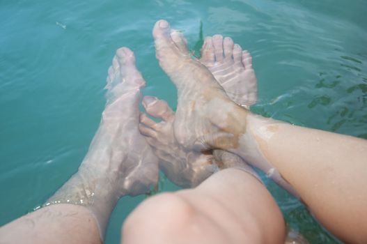 two feet of asian couple lover in water - romantic scene