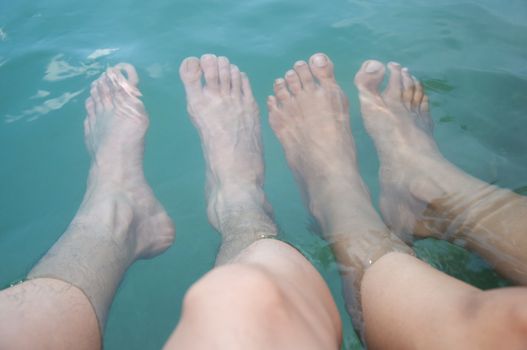 two feet of asian couple lover in water - romantic scene