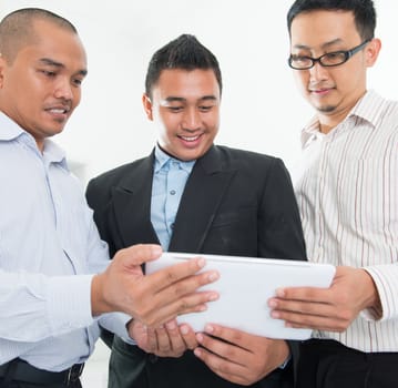 Southeast Asian businessmen having a discussion in office background