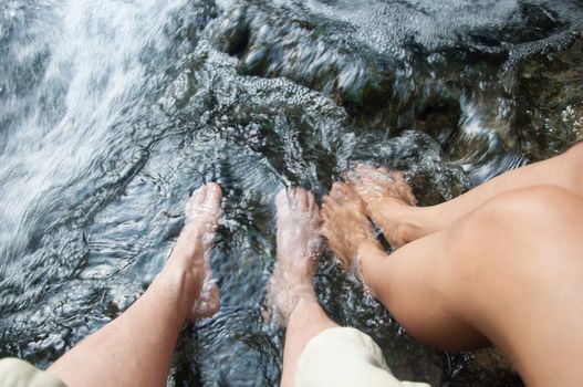 two feet of asian couple lover in water - romantic scene