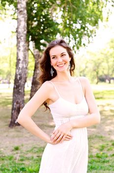 Portrait of an attractive woman in the park, smiling and happy