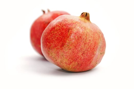 Two red  pomegranates on white background