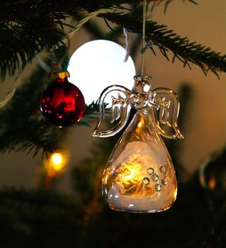 Christmas angel in glass hanging in tree