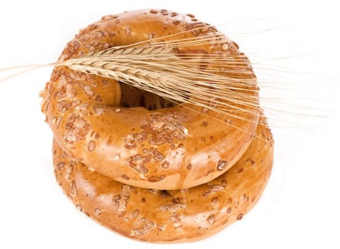 Bagels with wheat ears on white
