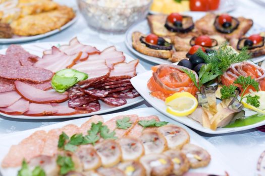 Sliced sausage, served on plates on the festive table