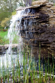 stone structure with a waterfall. Fountain in City Park