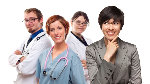 Young Mixed Race Woman with Doctors and Nurses Behind Isolated on a White Background.